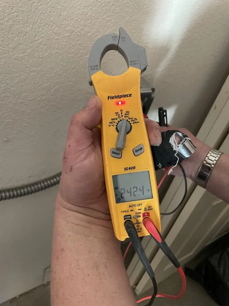 Voltage testing with clamp meter during Electrical Installation Services in Bennington